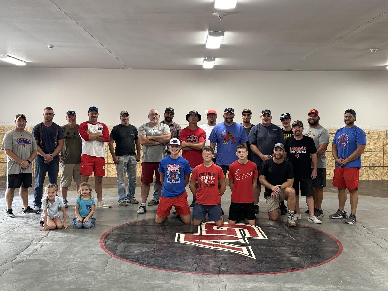 Volunteers and wrestlers on the new mats